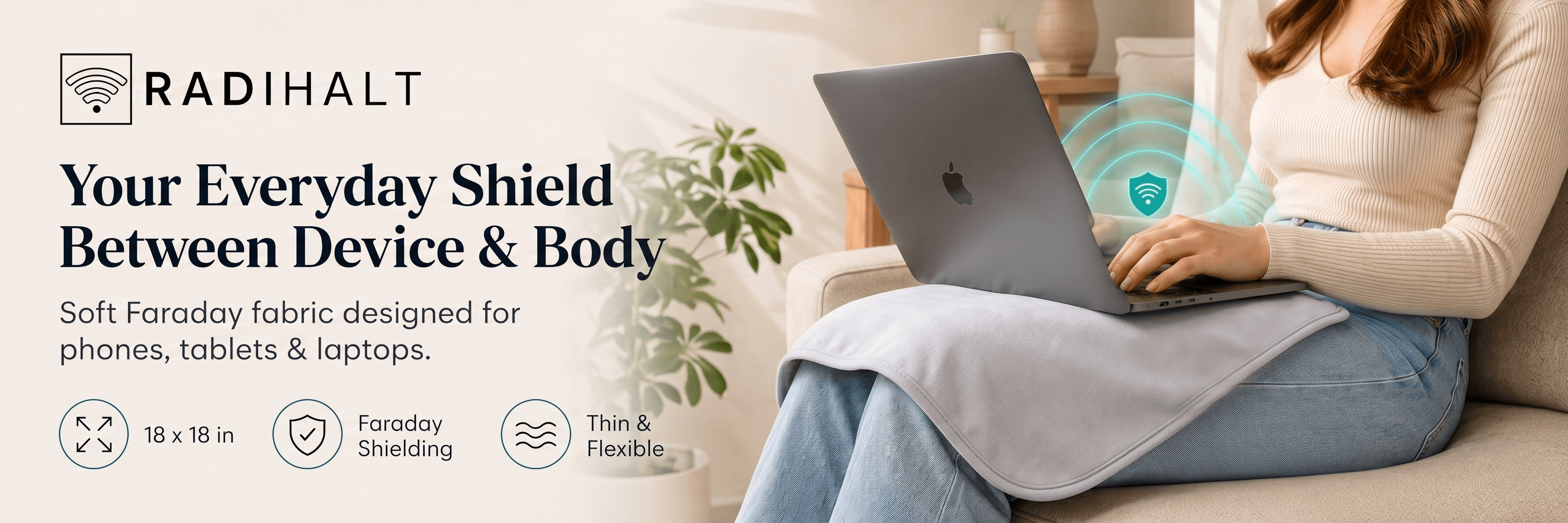 Person using a laptop with a RADIHALT Faraday blanket across their lap